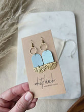 Load and play video in Gallery viewer, Baby Blue Leather & Brass Sunburst Geometric Earrings