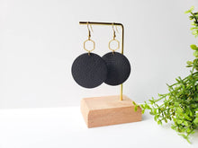 Load image into Gallery viewer, Large Black Leather Disc & Brass Hexagon Dangle Earrings.