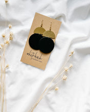 Load image into Gallery viewer, Black Leather Disc & Brass Half Moon Stacked Dangle Earrings.