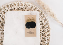 Load image into Gallery viewer, Black Leather Disc & Brass Half Moon Stacked Dangle Earrings.