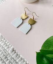 Load image into Gallery viewer, white leather earrings with a brass accent on top