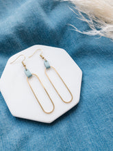 Load image into Gallery viewer, blue leather on a large brass oval statement earring
