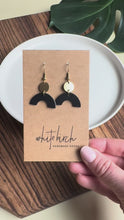 Load and play video in Gallery viewer, Smooth Black Leather Arch and Tiny Brass Disc Earrings
