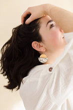 Load image into Gallery viewer, terrazzo print cork backed leather earrings in a half moon shape with a brass half moon stacked on top

