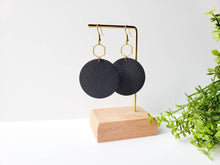 Load image into Gallery viewer, Large Black Leather Disc &amp; Brass Hexagon Dangle Earrings.
