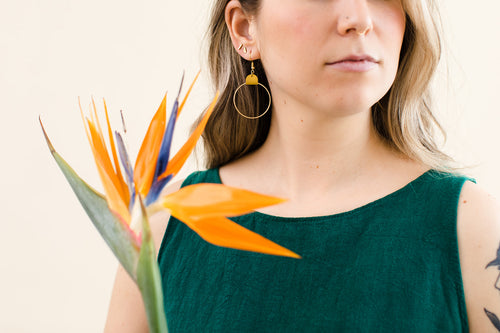 mustard yellow leather earrings with a brass circle