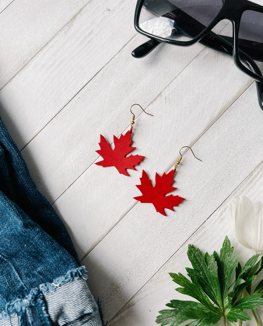 canada red leather earrings in the shape of a maple leaf
